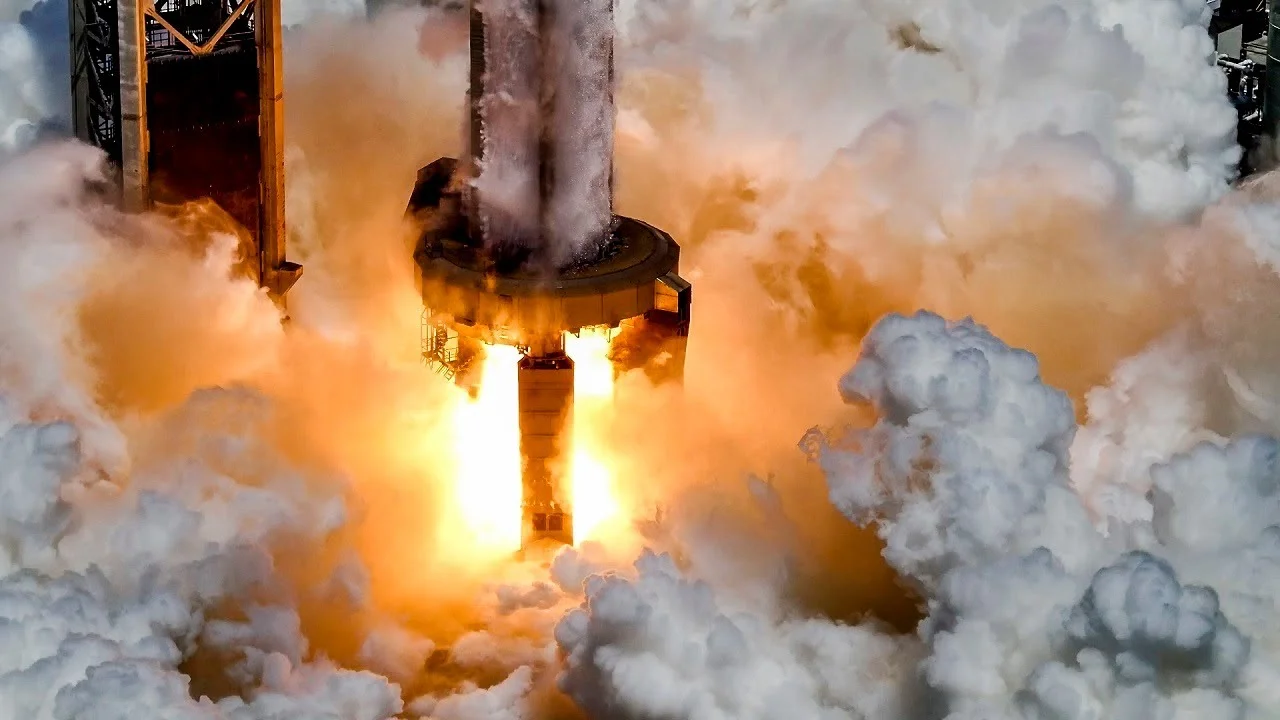 A shot of the rocket lifting off in a fiery blast, showcasing the 33 Raptor engines in action.